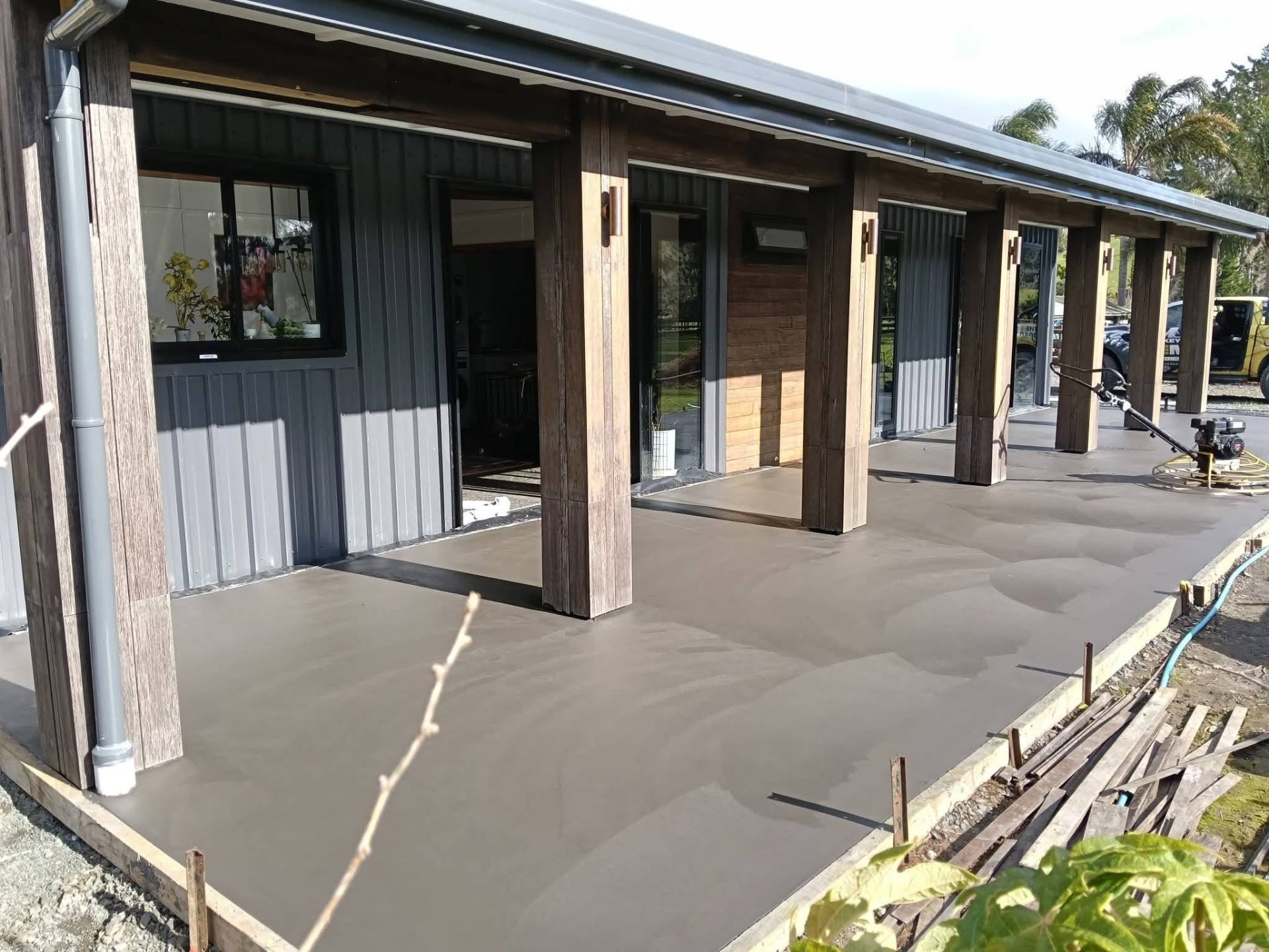 Finished concrete patio and veranda surround on a modern Northland home by Henwood Concrete.