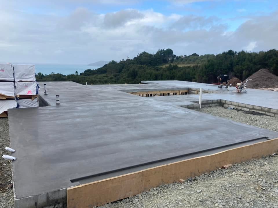 Large freshly poured concrete house slab with timber formwork overlooking the Northland coast, by Henwood Concrete.